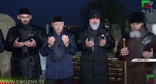 Magomed Daudov, the speaker of the Chechen parliament, Ruslan Alkhanov, Minister of Interior for Chechnya, Adam Delimkhanov, the advisor to the leader of Chechnya, and Salakh Mezhiev, Mufti of Chechnya the grave of Akhmat Kadyrov in Akhmat-Yurt. Screenshot: https://www.youtube.com/watch?v=rTNrwO_-jl4&feature=emb_title Magomed Daudov, the speaker of the Chechen parliament, Ruslan Alkhanov, Minister of Interior for Chechnya, Adam Delimkhanov, the advisor to the leader of Chechnya, and Salakh Mezhiev, Mufti of Chechnya the grave of Akhmat Kadyrov in Akhmat-Yurt. Screenshot: https://www.youtube.com/watch?v=rTNrwO_-jl4&feature=emb_title
