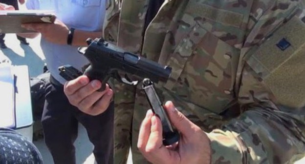 Law enforcer holding a gun. Photo: Krasnodar Department of the Ministry of Internal Affairs Law enforcer holding a gun. Photo: Krasnodar Department of the Ministry of Internal Affairs