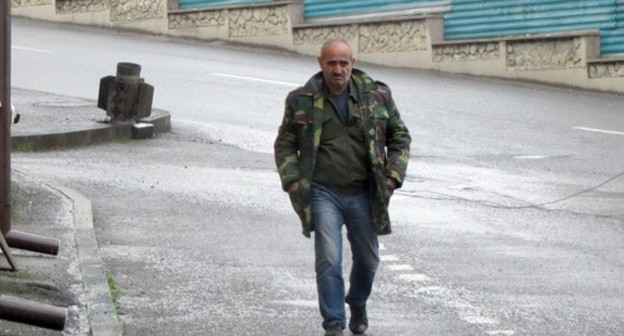 A man walking on street in Stepanakert with an unexploded shell in the background. Photo by Alvard Grigoryan for the "Caucasian Knot" A man walking on street in Stepanakert with an unexploded shell in the background. Photo by Alvard Grigoryan for the "Caucasian Knot"