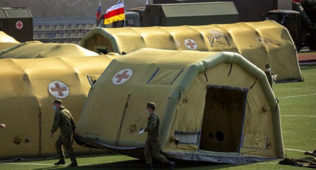 Russian military personnel setting up a mobile hospital in Tskhinvali for patients diagnosed with COVID-19. Photo: press service of the Ministry of Defence of Russia, https://function.mil.ru/images/upload/2019/4U5A9820.jpg Russian military personnel setting up a mobile hospital in Tskhinvali for patients diagnosed with COVID-19. Photo: press service of the Ministry of Defence of Russia, https://function.mil.ru/images/upload/2019/4U5A9820.jpg