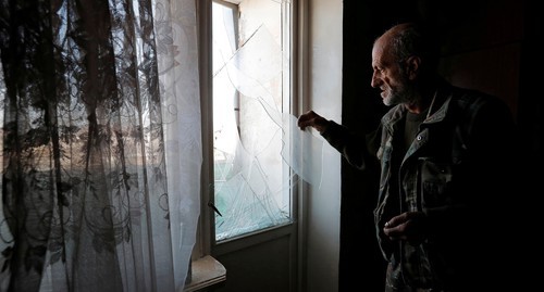 A man removes glass fragments from a window damaged as a result of shelling of Stepanakert, October 13, 2020. Photo: REUTERS/Stringer A man removes glass fragments from a window damaged as a result of shelling of Stepanakert, October 13, 2020. Photo: REUTERS/Stringer