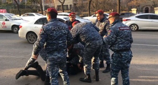 Policemen detain a man. Screenshot of video posted at Ishkhan Sagatelyan's Facebook page Policemen detain a man. Screenshot of video posted at Ishkhan Sagatelyan's Facebook page
