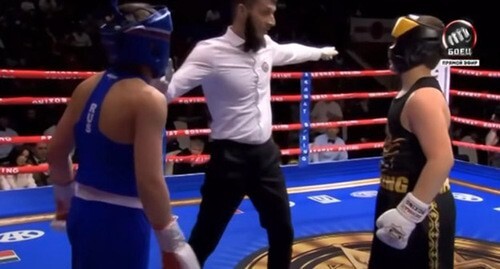 The boxing match of Adam Kadyrov (dressed in black) with Aslan Bittirov. Screenshot of the video https://youtu.be/GrfMEoDgbrE The boxing match of Adam Kadyrov (dressed in black) with Aslan Bittirov. Screenshot of the video https://youtu.be/GrfMEoDgbrE