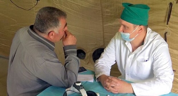Military doctor and local resident in the village of Aknaberd of the Shaumyan District of Nagorno-Karabakh. Photo courtesy of the press service of the Russian Ministry of Defence Military doctor and local resident in the village of Aknaberd of the Shaumyan District of Nagorno-Karabakh. Photo courtesy of the press service of the Russian Ministry of Defence