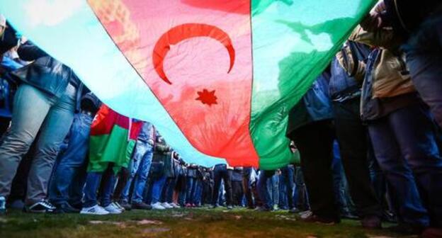 The flag of Azerbaijan at a protest action. Photo by Aziz Karimov for the "Caucasian Knot" The flag of Azerbaijan at a protest action. Photo by Aziz Karimov for the "Caucasian Knot"