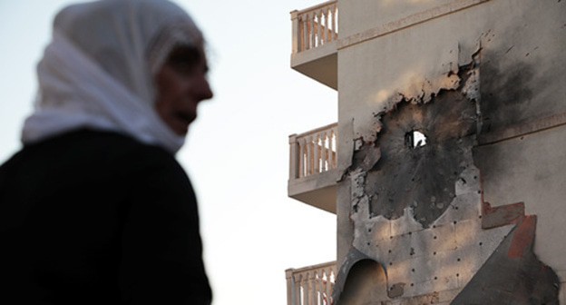 A woman at a destroyed building in Syria. Photo: REUTERS/Sertac Kayar A woman at a destroyed building in Syria. Photo: REUTERS/Sertac Kayar
