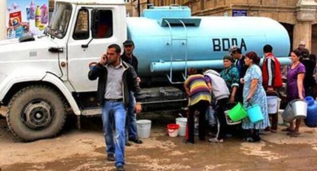 People stand in line at a vehicle with water, Dagestan. Abstract illustration. Photo by Makhach Akhmedov for the Caucasian Knot People stand in line at a vehicle with water, Dagestan. Abstract illustration. Photo by Makhach Akhmedov for the Caucasian Knot