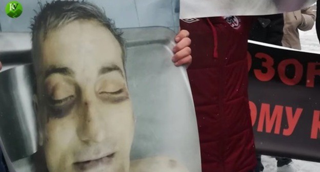 A poster showing traces of torture on Vladimir Tskaev's face. Screenshot of the video by the "Caucasian Knot" https://www.youtube.com/watch?v=1Fwh_EBWCo0 A poster showing traces of torture on Vladimir Tskaev's face. Screenshot of the video by the "Caucasian Knot" https://www.youtube.com/watch?v=1Fwh_EBWCo0