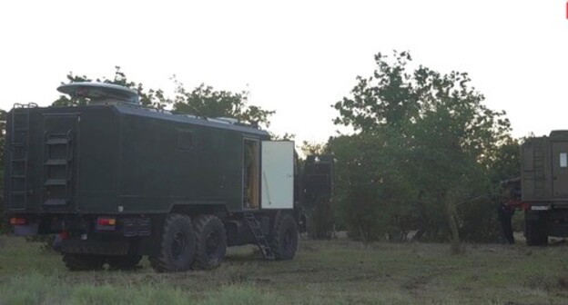 Military vehicles at the site of the counterterrorist operation (CTO) conducted by law enforcers in the forest near the village of Talgi. Screenshot of the video by the Russian National Antiterrorism Committee (NAC) Military vehicles at the site of the counterterrorist operation (CTO) conducted by law enforcers in the forest near the village of Talgi. Screenshot of the video by the Russian National Antiterrorism Committee (NAC)