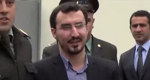 Taleh Bagirzade is being escorted by policemen. Image made from video posted by haqq sunna: https://www.youtube.com/watch?v=MPjaXBsKwD4 Taleh Bagirzade is being escorted by policemen. Image made from video posted by haqq sunna: https://www.youtube.com/watch?v=MPjaXBsKwD4