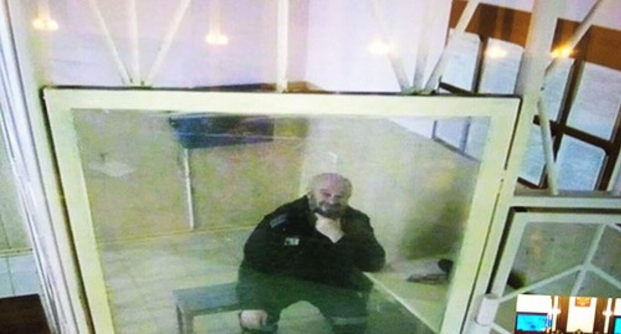 Aslambek Ezhaev on a screen in a courtroom. Photo by the "Caucasian Knot" correspondent Aslambek Ezhaev on a screen in a courtroom. Photo by the "Caucasian Knot" correspondent