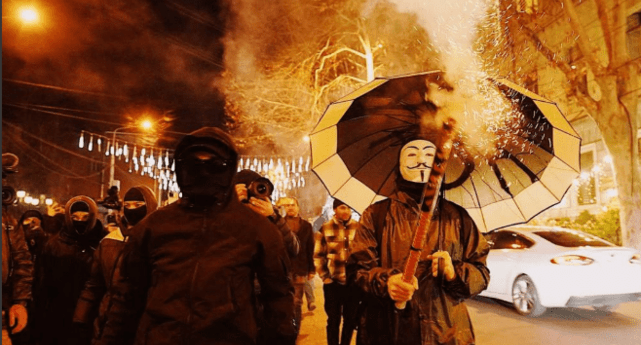 Protesters in masks. Screenshot of a photo posted by Publika on January 18, 2025 https://www.facebook.com/publika.ge/posts/pfbid0gy9s2mivFT515x1ngVSDDcbfyAXkU9oUqbd39zE3YtBiQ1DJr5qDYNemNVuCpYjTl the activities of the Meta Company, owning Facebook, are banned in Russia Protesters in masks. Screenshot of a photo posted by Publika on January 18, 2025 https://www.facebook.com/publika.ge/posts/pfbid0gy9s2mivFT515x1ngVSDDcbfyAXkU9oUqbd39zE3YtBiQ1DJr5qDYNemNVuCpYjTl the activities of the Meta Company, owning Facebook, are banned in Russia