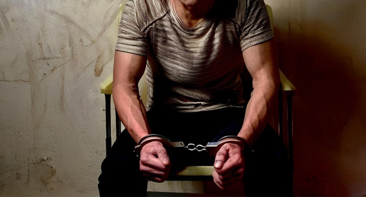 A detainee in handcuffs. Picture made in Photoshop by the "Caucasian Knot" A detainee in handcuffs. Picture made in Photoshop by the "Caucasian Knot"