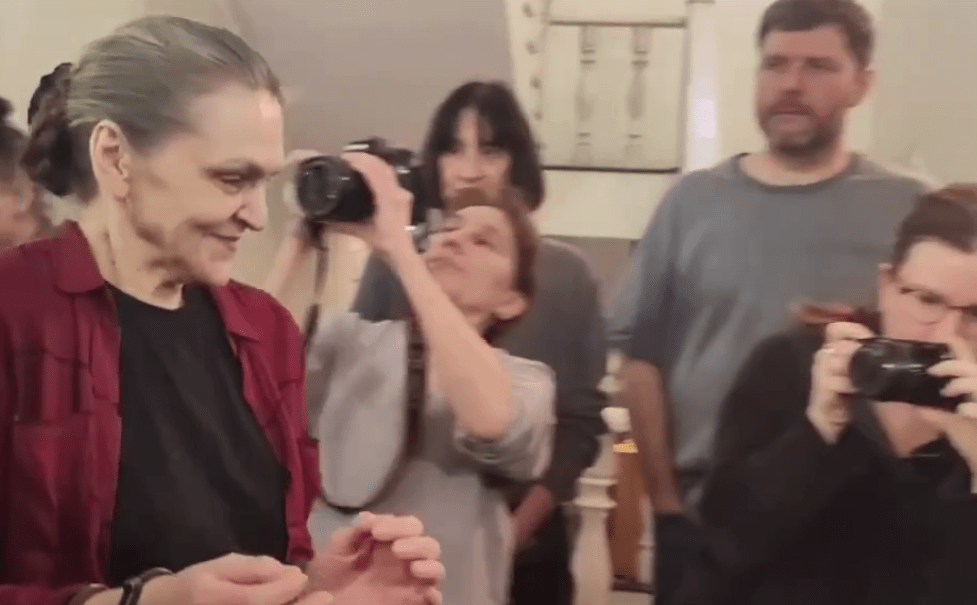 Nadezhda Kevorkova in handcuffs is lead to a courtroom. Screenshot of a video posted by the RusNews on March 12, 2025, https://t.me/rusnews/68047