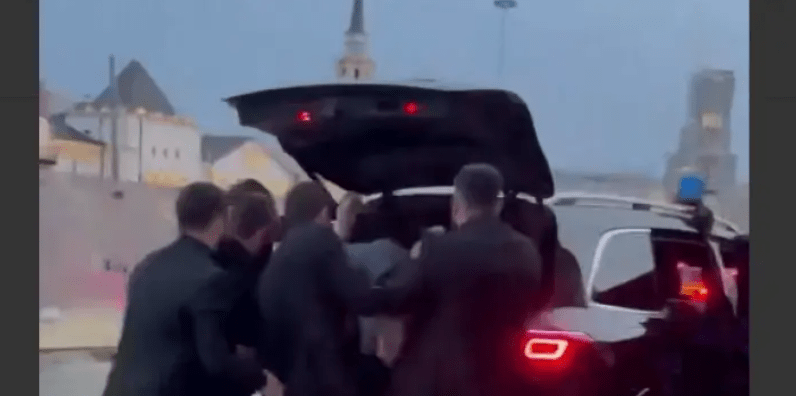 Chechen enforcers put Areg Shchepikhin in the trunk. Still image of Caucasian Knot video, https://www.youtube.com/shorts/lqkgd7MfIM8 Chechen enforcers put Areg Shchepikhin in the trunk. Still image of Caucasian Knot video, https://www.youtube.com/shorts/lqkgd7MfIM8