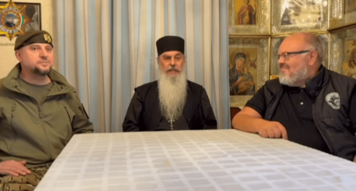 Apti Alaudinov, Schema-Abbot Gabriel, and Andrei Kormukhin (from left to right). Still frame from a video posted on the Apti Alaudinov’s Telegram channel and dated June 19, 2025, https://t.me/AptiAlaudinovAKHMAT/11559.
Apti Alaudinov, Schema-Abbot Gabriel, and Andrei Kormukhin (from left to right). Still frame from a video posted on the Apti Alaudinov’s Telegram channel and dated June 19, 2025, https://t.me/AptiAlaudinovAKHMAT/11559.