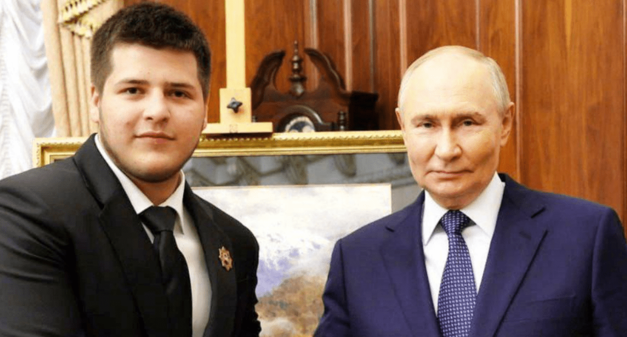 Adam Kadyrov (left) with Vladimir Putin. Screenshot of a photo from Ramzan Kadyrov's Telegram channel from 06/28/25, https://t.me/RKadyrov_95/5808 Adam Kadyrov (left) with Vladimir Putin. Screenshot of a photo from Ramzan Kadyrov's Telegram channel from 06/28/25, https://t.me/RKadyrov_95/5808