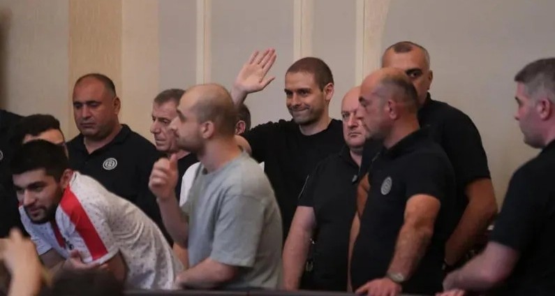 The accused in the courtroom. Photo: "Interpressnews" https://www.interpressnews.ge/ru/article/169923-sud-ne-udovletvoril-ni-odnogo-khodataistva-ob-izmenenii-mery-presecheniia-v-otnoshenii-andro-chichinadze-onise-tskhadadze-i-eshche-9-lits-i-ostavil-v-zakliuchenii-vsekh-obviniaemykh The accused in the courtroom. Photo: "Interpressnews" https://www.interpressnews.ge/ru/article/169923-sud-ne-udovletvoril-ni-odnogo-khodataistva-ob-izmenenii-mery-presecheniia-v-otnoshenii-andro-chichinadze-onise-tskhadadze-i-eshche-9-lits-i-ostavil-v-zakliuchenii-vsekh-obviniaemykh