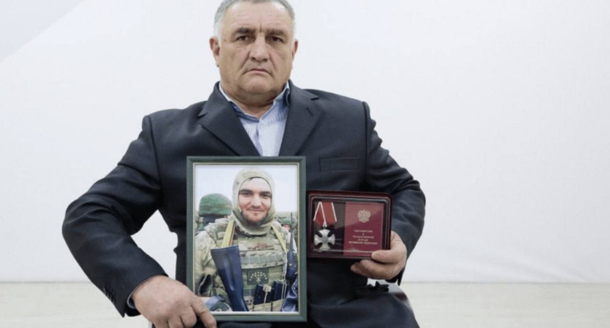 Ramazan Aripshev's father with his son's portrait and award. Screenshot of a photo from the Telegram channel of the Defenders of the Fatherland Foundation in Kabardino-Balkaria from 04.08.25, https://t.me/fond_ZO_kbr/7081. Ramazan Aripshev's father with his son's portrait and award. Screenshot of a photo from the Telegram channel of the Defenders of the Fatherland Foundation in Kabardino-Balkaria from 04.08.25, https://t.me/fond_ZO_kbr/7081.