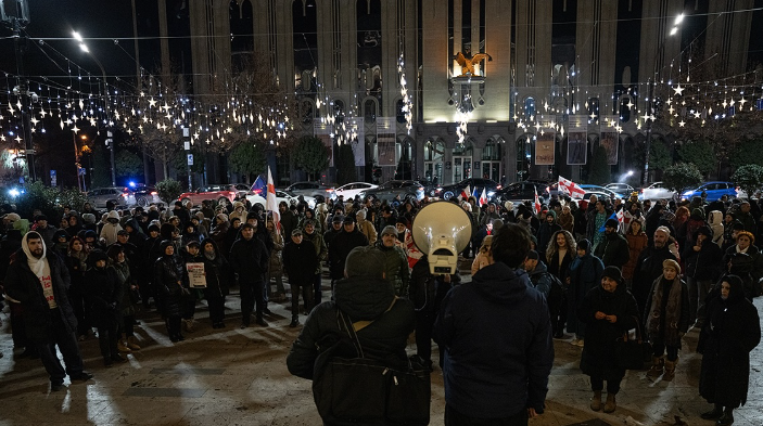 Protesters outside the Georgian Parliament. Screenshot from Publika photo from December 26, 2025, https://www.facebook.com/photo?fbid=1639520170780860&set=pcb.1639520224114188