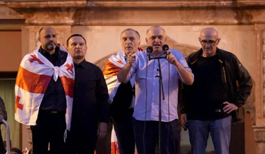 From left to right: Irakli Nadiradze, Paata Manzhgaladze, Paata Burchuladze, Murtaz Zodelava, Lasha Beridze at the rally 04.10.25. Screenshot of photo "Interpressnews" https://www.interpressnews.ge/ru/article/174819-po-delu-4-oktiabria-paata-burchuladze-murtaz-zodelava-iraklii-nadiradze-lasha-beridze-i-paata-ma ndzhgaladze-prigovoreny-k-7-tornike-mchedlishvili-nika-gventsadze-iraklii-chkhvirkiia-k-5-a-iraklii-shaishmelashvili-k-2-godam-lisheniia-svobody.